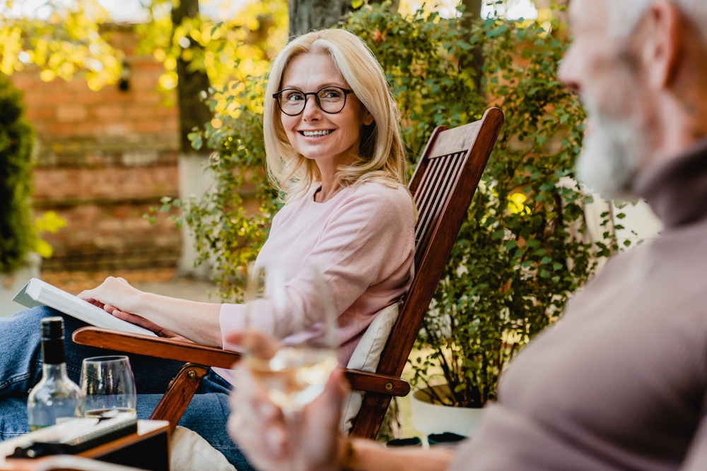A patient enjoys reading outdoors with clear vision and stylish eyewear, highlighting comprehensive eye care and personalized treatment from a trusted optometrist in the San Francisco Bay Area - Optometrist in San Francisco