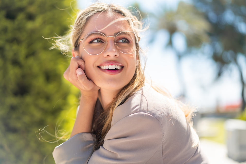 A patient smiles confidently in fashionable eyeglasses, reflecting expert eye exams, precise prescriptions, and personalized vision solutions from a trusted optometrist in San Francisco - Optometrist in San Francisco